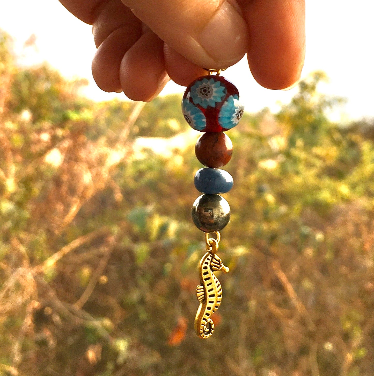 Immerse yourself in the beauty of the ocean with our jasper and blue opal pendant, featuring a delightful sea horse. Swim with the currents of intuition always.
ChakPendantSpectakSea horse Serenade