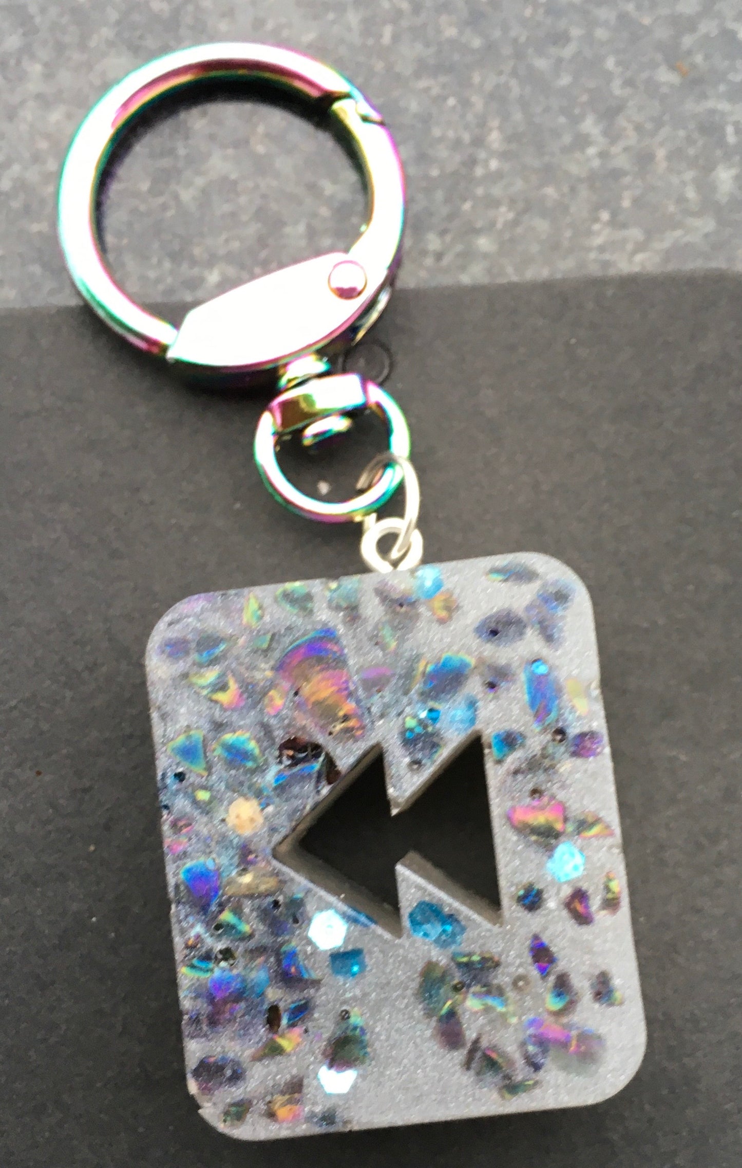 Take a moment to rewind , reflect, reboot and recharge with our nostalgic REWIND keychain, with crystal chips.KeychainSpectakRewind