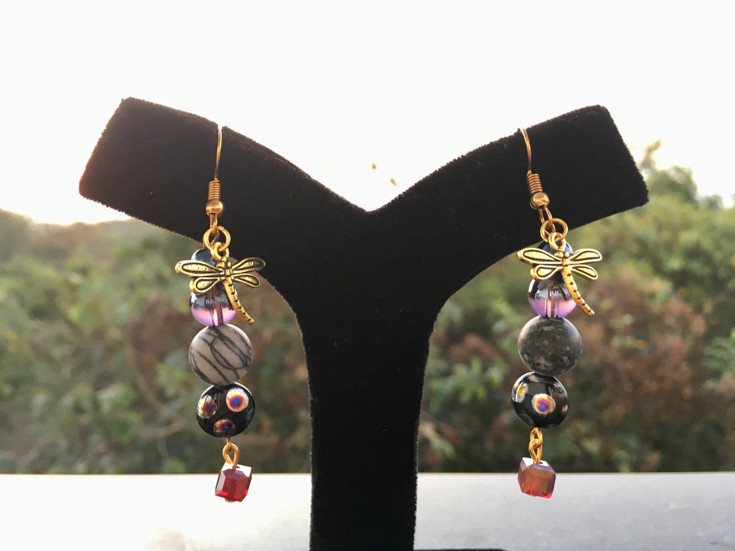 Capture the mystical beauty of nature with our earrings, featuring Spider web Jasper and delicate dragonfly charms.These enchanting earrings embody balance, transforEarringsSpectakWhispering Wings