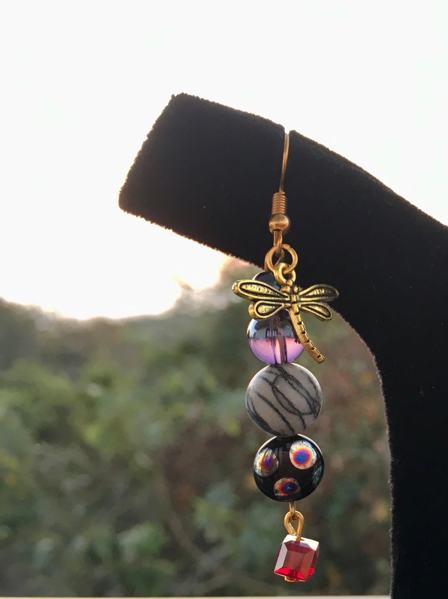 Capture the mystical beauty of nature with our earrings, featuring Spider web Jasper and delicate dragonfly charms.These enchanting earrings embody balance, transforEarringsSpectakWhispering Wings