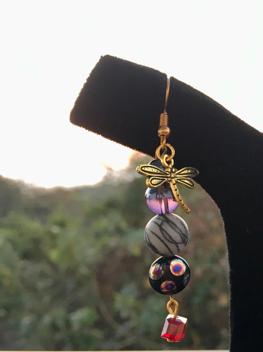 Capture the mystical beauty of nature with our earrings, featuring Spider web Jasper and delicate dragonfly charms.These enchanting earrings embody balance, transforEarringsSpectakWhispering Wings