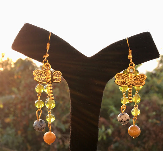 Soar into wisdom and serenity with our dragonfly dangle earrings, featuring sodalite and peach aventurine. These enchanting earrings symbolize transformation, intuitEarringsSpectakWinged Wisdom