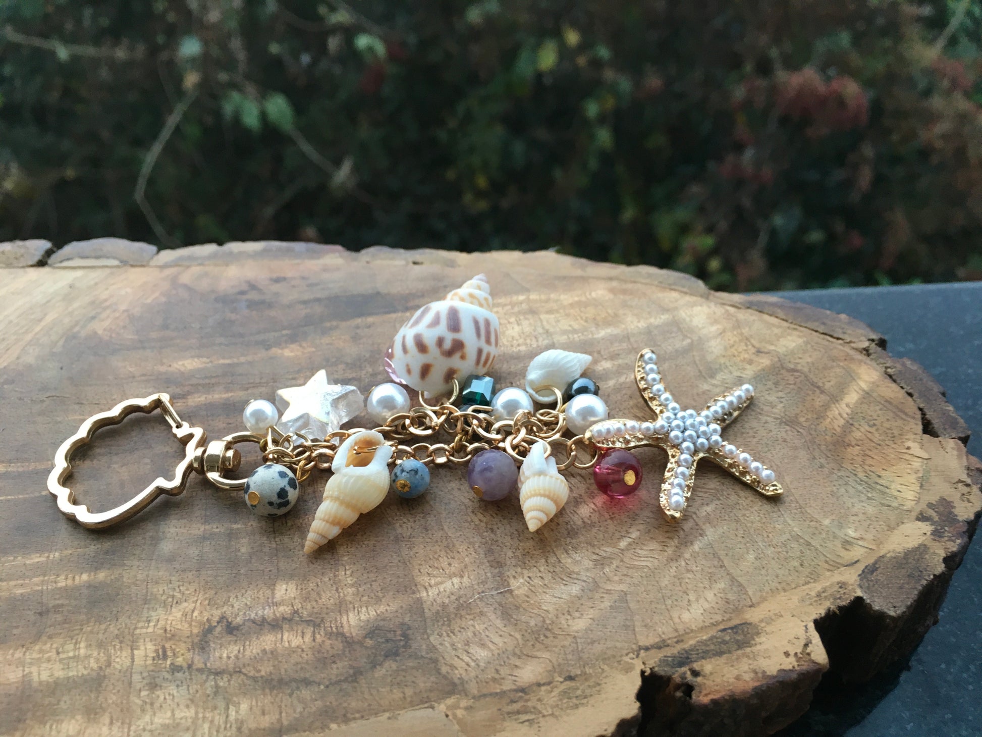 Embrace the essence of goa, with this beautiful  keychain. Made with genuine shells and crystals, this charming accessory adds a touch of bohemian charm to your keysKeychainSpectakBohemian Rhapsody