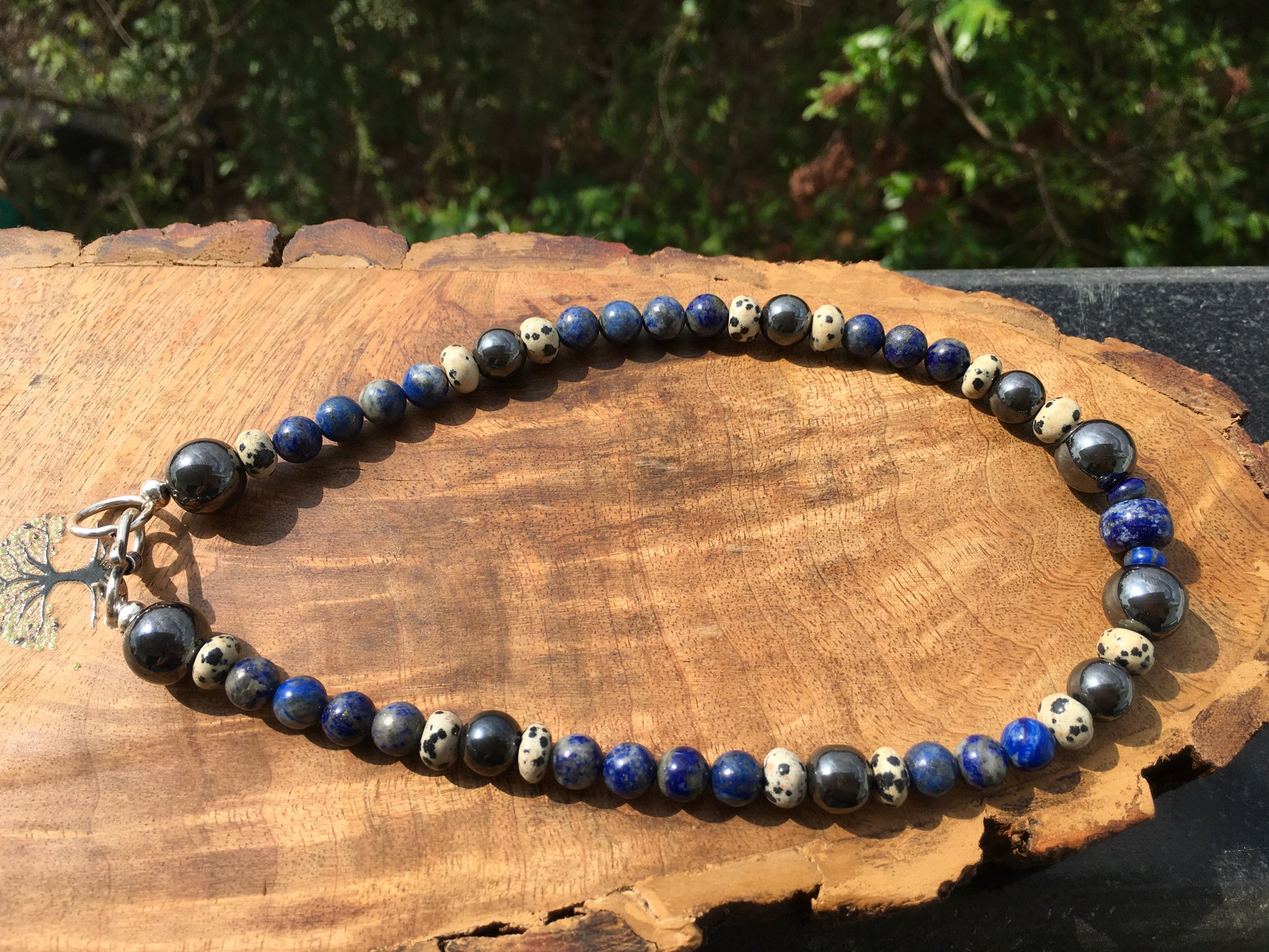 Embody the powerful energies of Hematite, Lapis lazuli and Dalmatian Jasper with this amazing necklace.
Hematite grounds, protects and promotes inner strength and peNecklacesSpectakMindful Warrior