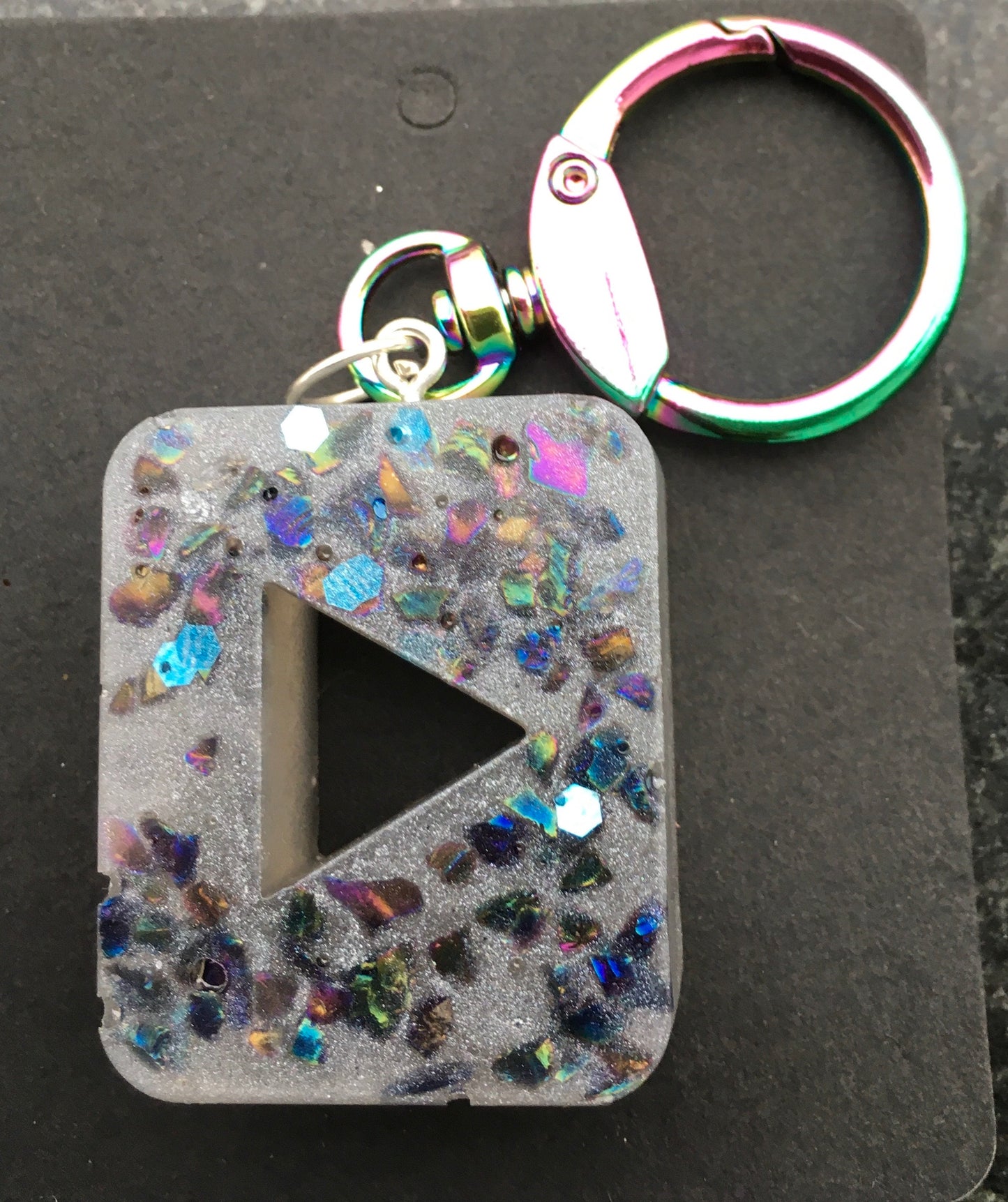 Rock your day with positive vibes! Our PLAY symbol keychain features crystal chips that amplify good energy and inspire creativity.KeychainSpectakPlay