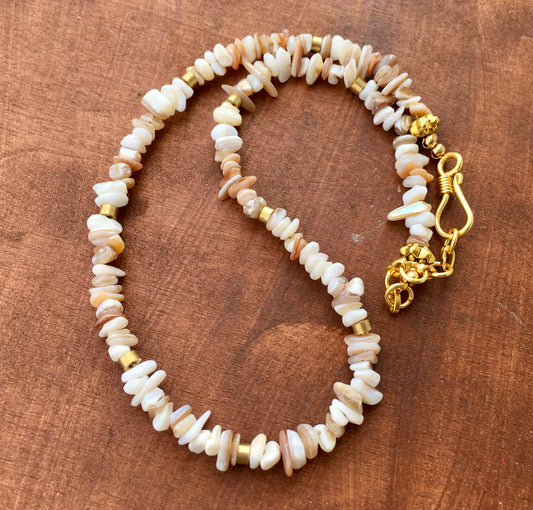 Embrace the serene beauty of the ocean with our Mother of Pearl Necklace. This exquisite piece features luminous Mother of Pearl chips crafted to showcase it’s naturNecklacesSpectakShimmering Tides